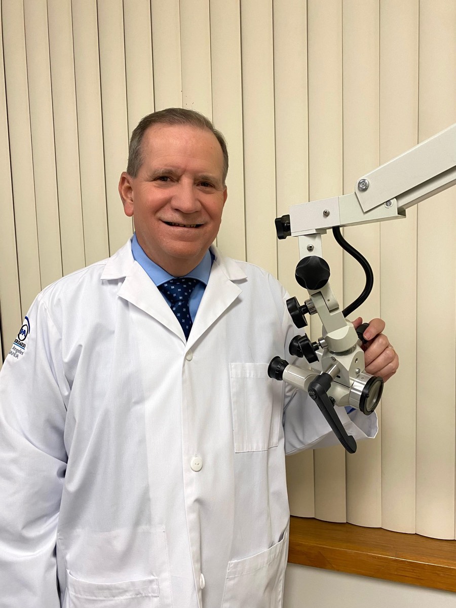 El Dr. José Alberto López Sisniega junto al microscopio de oído en su consultorio de Chihuahua